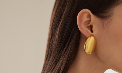 Profile of a woman wearing large gold earrings