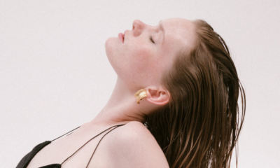 Model leans head back to reveal hammered gold Ben-Amun clip on earirngs