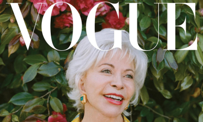 Isabel Allende wearing gold-plated Ben-Amun earrings against flower wall, with white Vogue logo