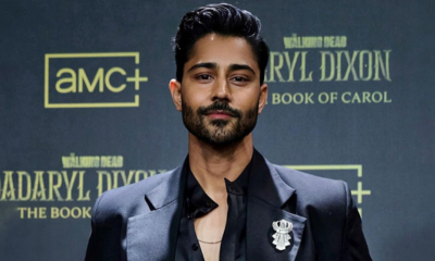 Manish Dayal in black suit and crystal pin