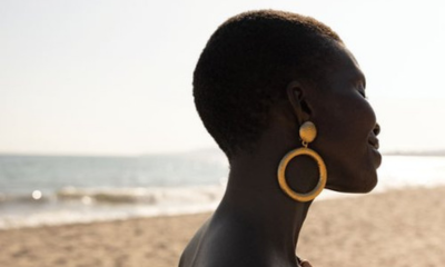 Achok Majak wears gold Ben-Amun earrings on the beach for Santa Barbara Magazine