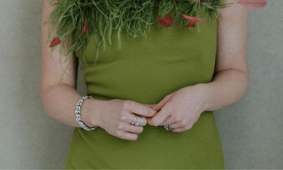 Lauren Ambrose in green feathered dress with pink petal details, wearing Ben-Amun crystal and pearl bracelet