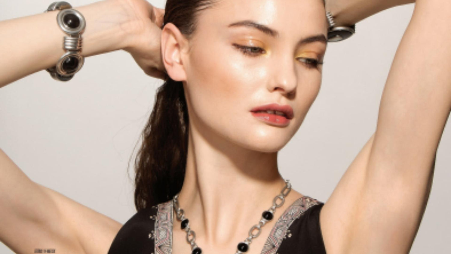 Model wearing silver and black Ben-Amun jewelry