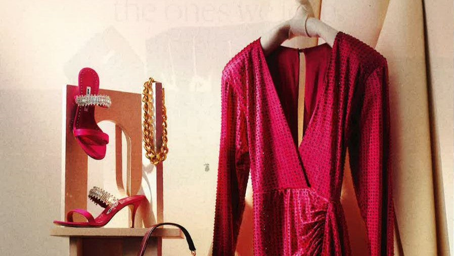 Pink dress and shoes sitting next to gold Ben-Amun jewelry