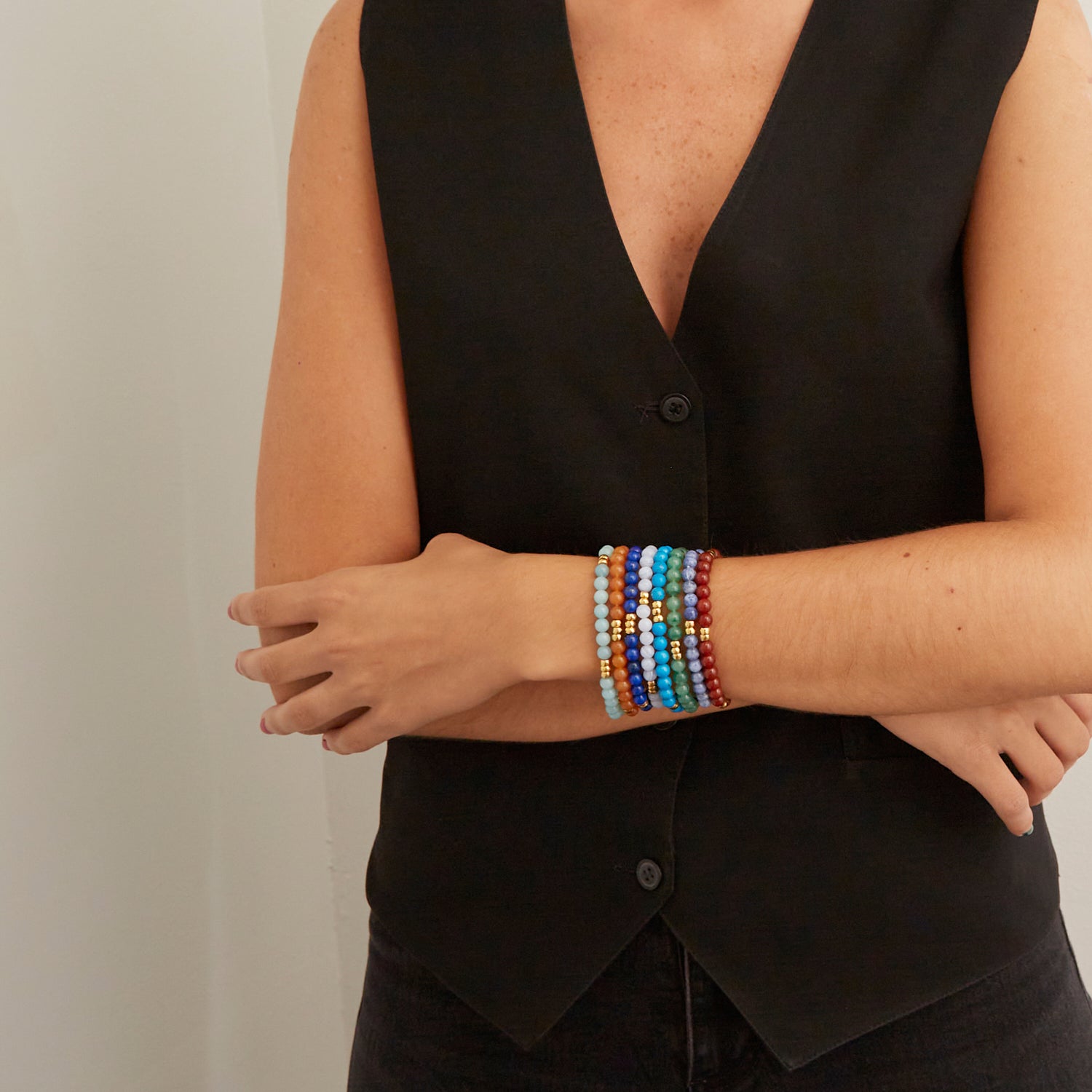 woman wearing colorful beaded bracelets