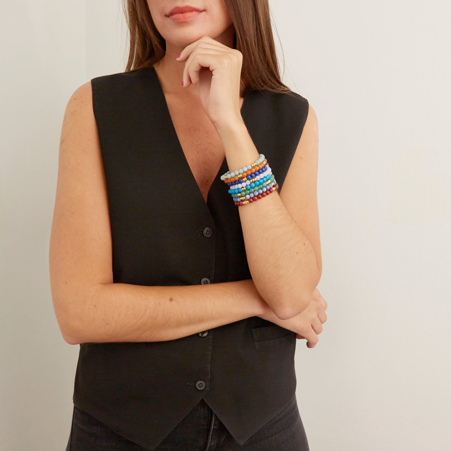 woman wearing colorful beaded bracelets