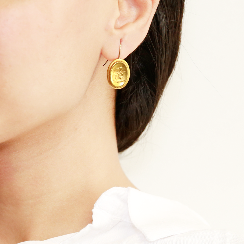 model wearing gold earrings