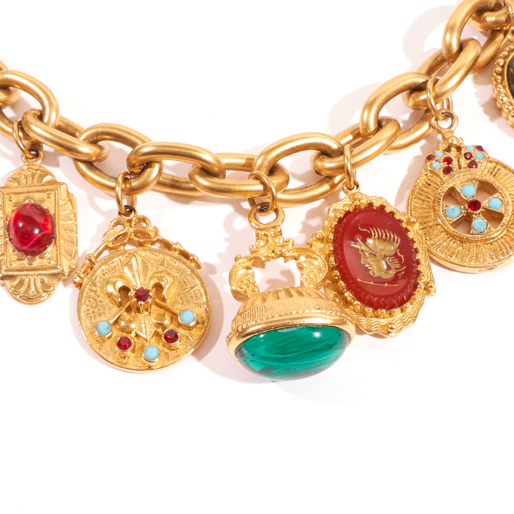 close up of charms featured on 24k gold plated chainlink bracelet 