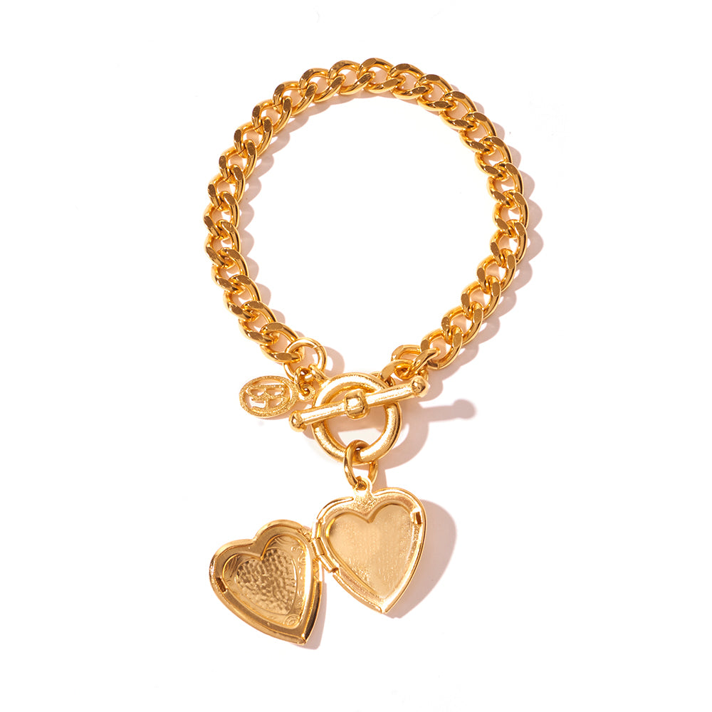 Gold link bracelet featuring open heart locket 