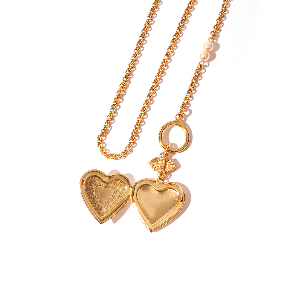 gold and pearl necklace with open heart locket 