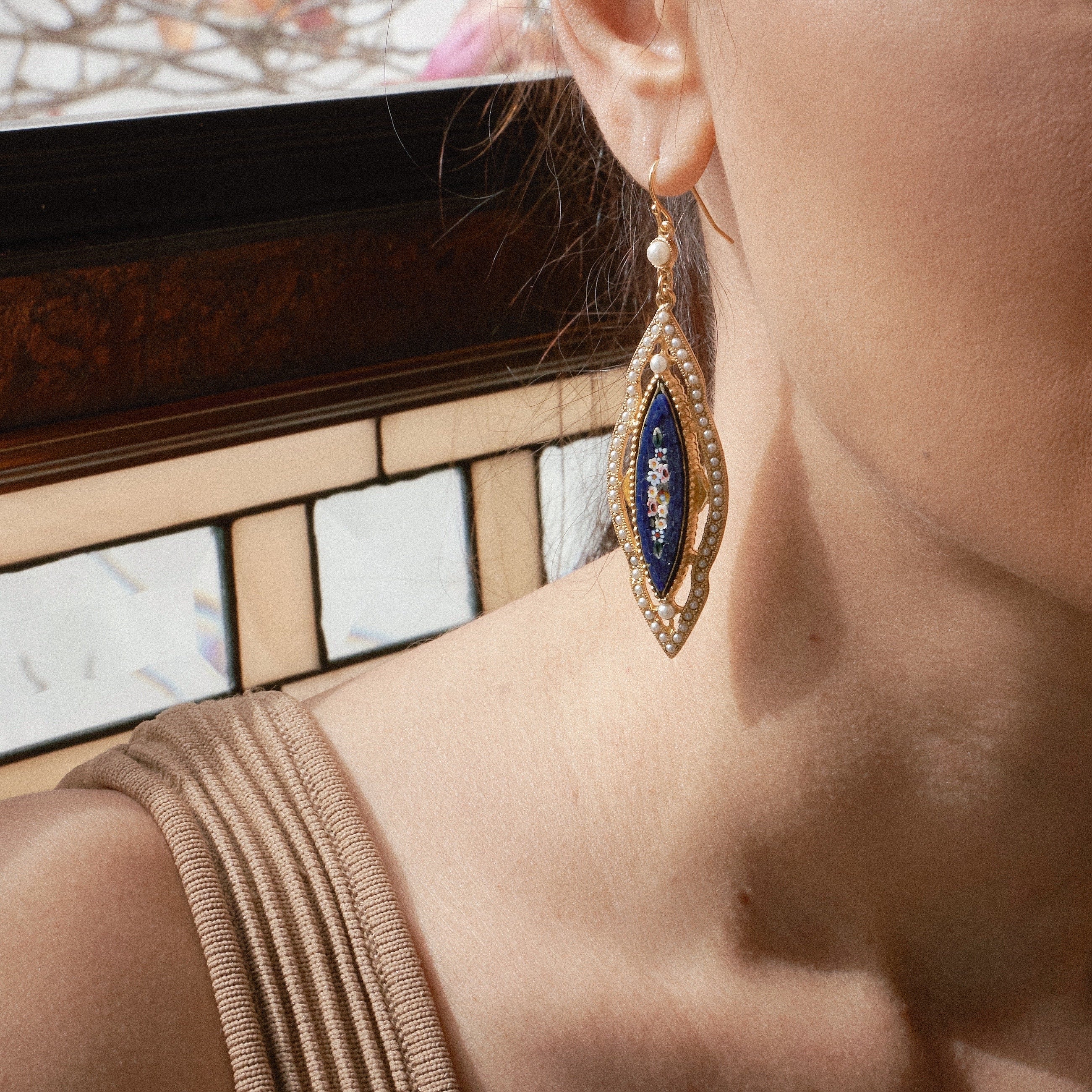 Model wearing Ben-Amun mosaic and pearl inlayed earring 
