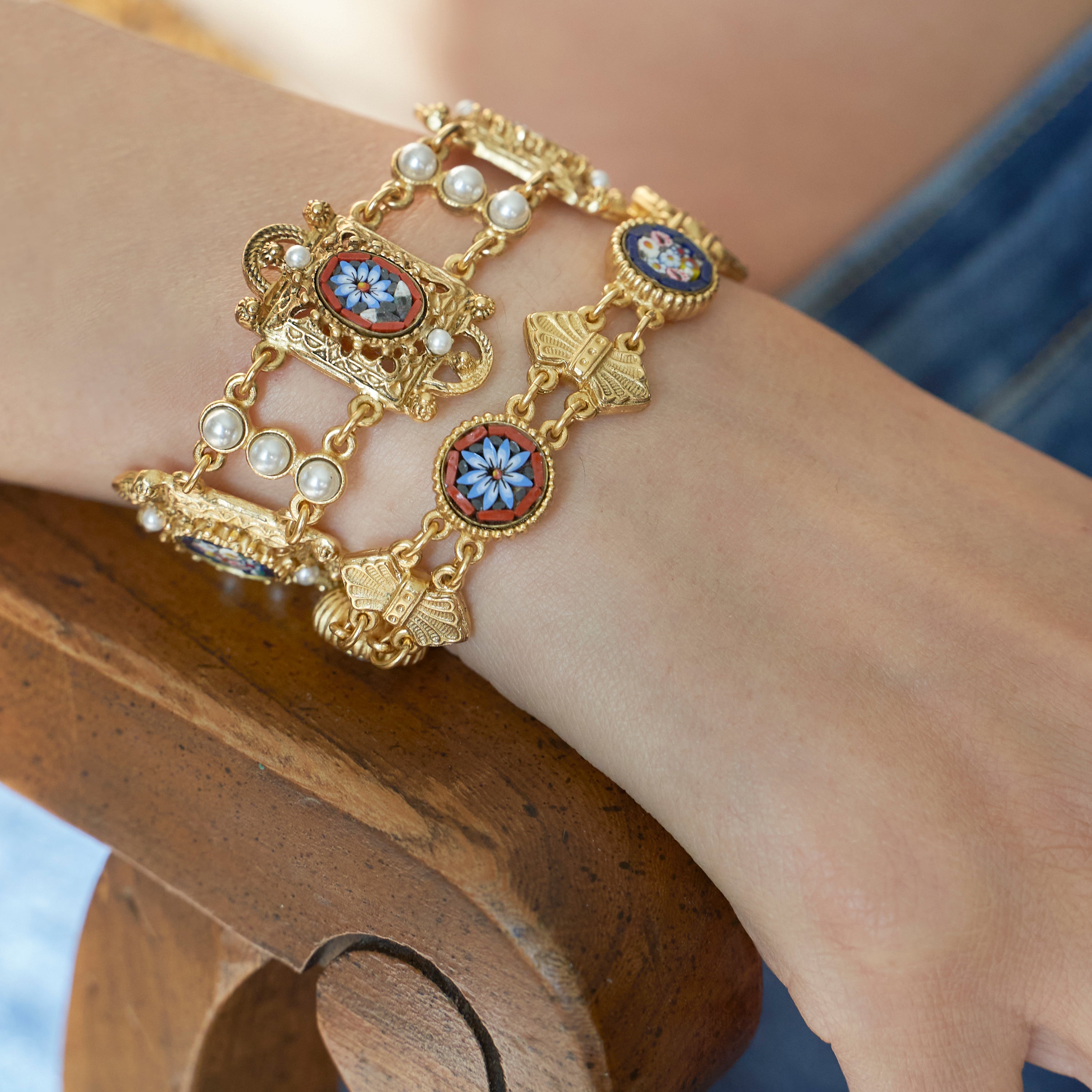 Model wearing two Ben-amun micro mosaic bracelets inlayed with pearls 