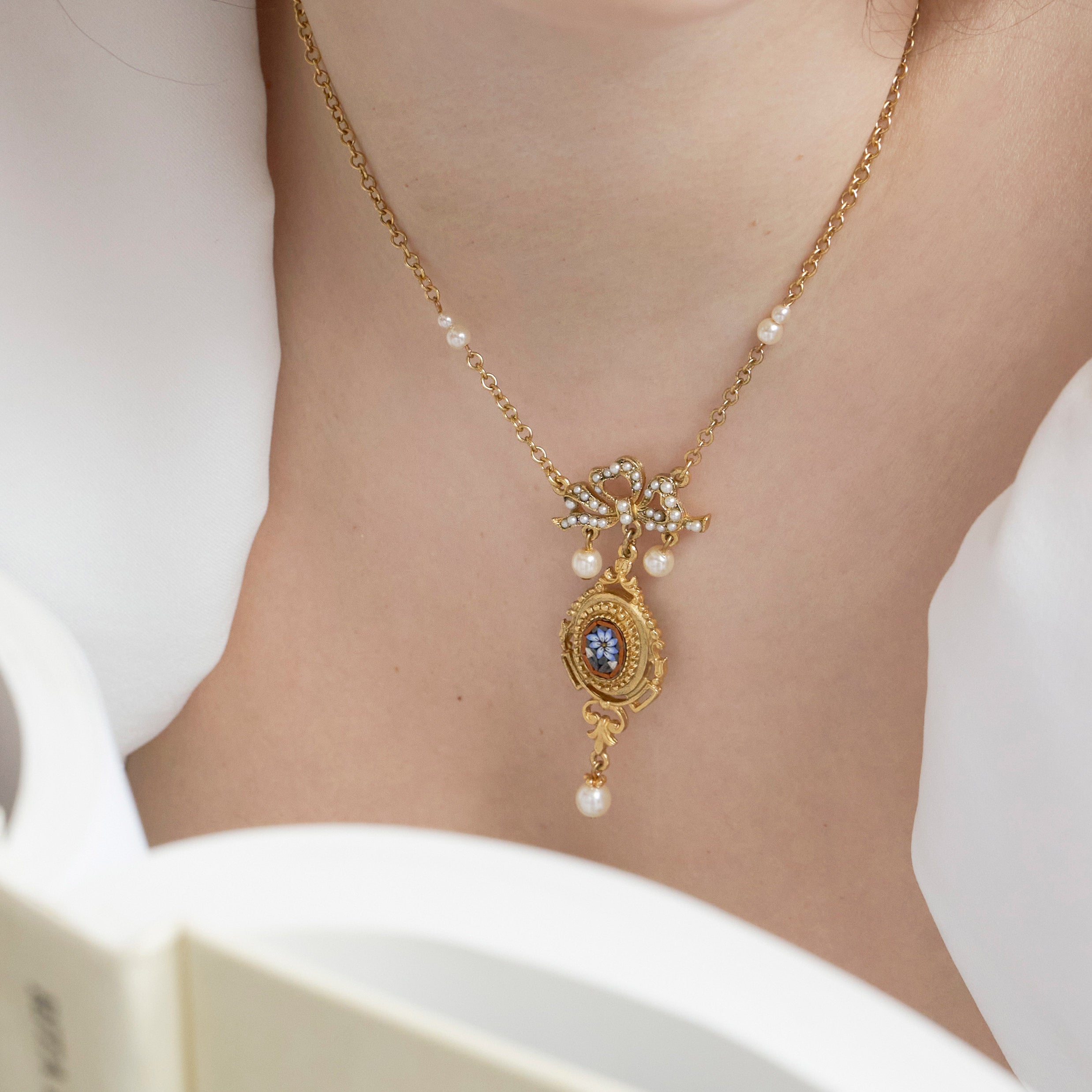 close up of Ben-Amun simple gold necklace inlayed with majorca pearls and micro-mosaic 