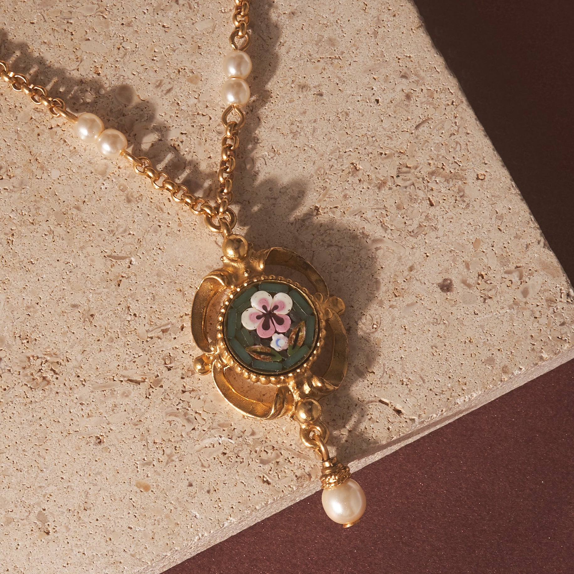 Ben-Amun Mella Necklace against stone and maroon background