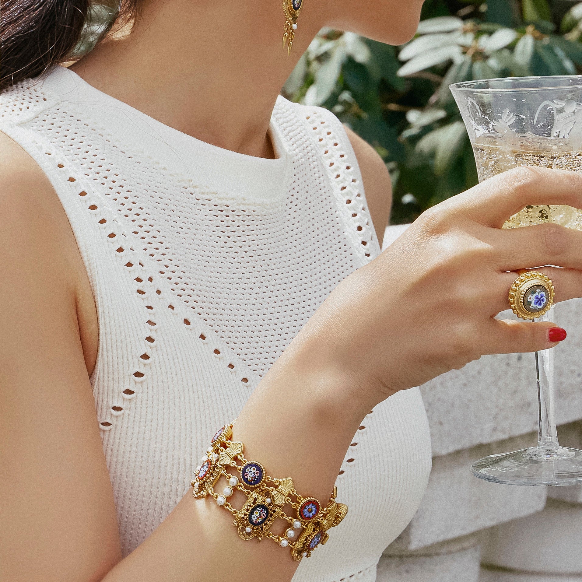 model wearing gold plated ring and bracelet both inlayed with micro mosaics