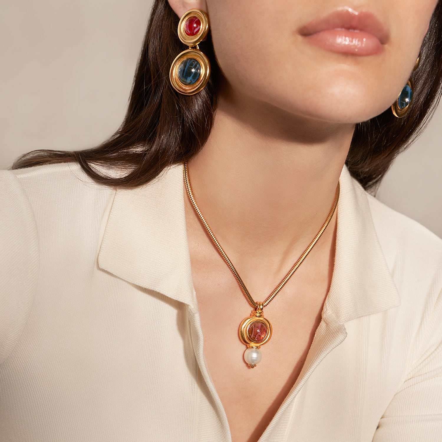 model wearing ben amun gold necklace and earrings