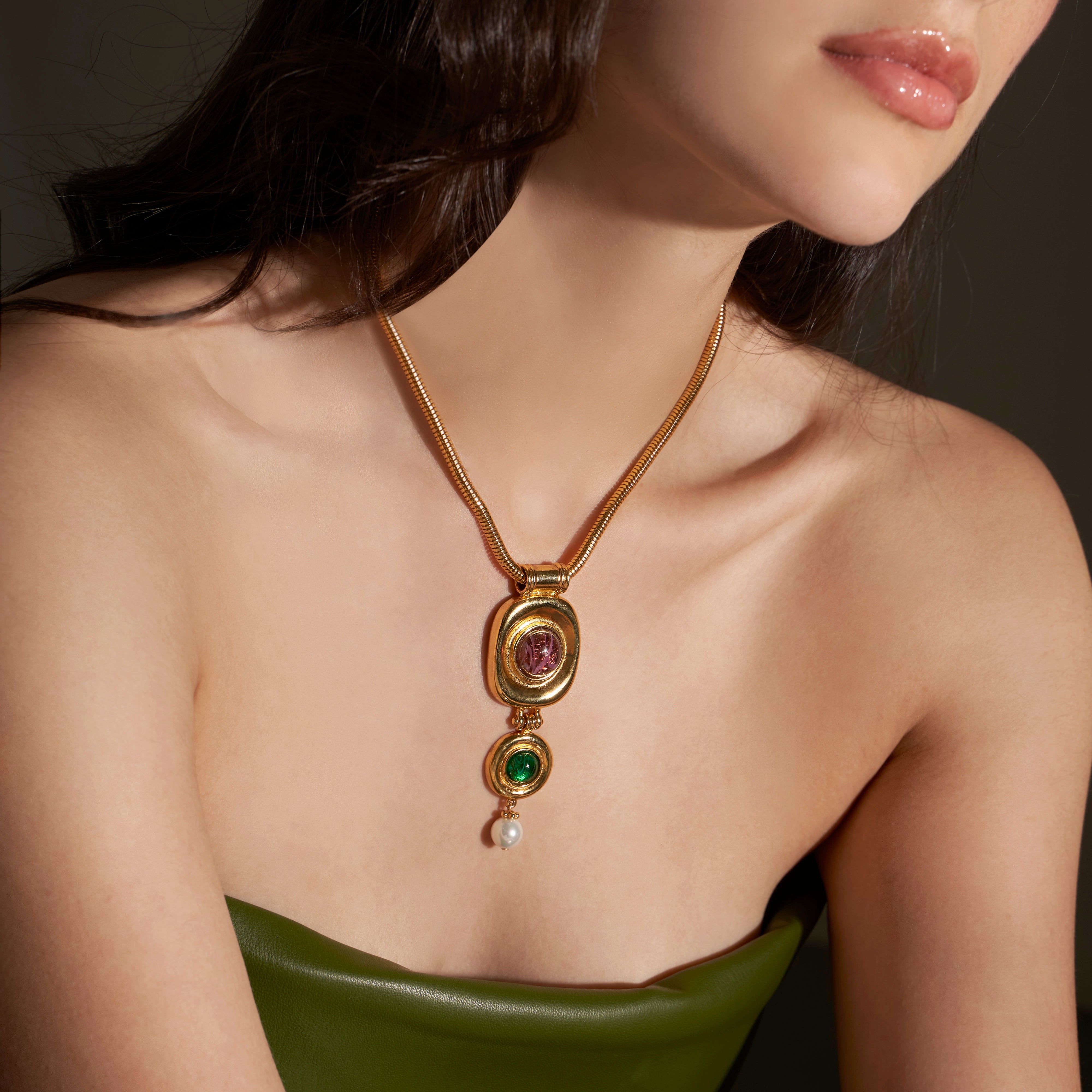 model wearing gold pendant drop necklace 