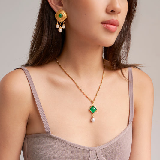 Model wearing thin gold necklace and earrings with pearls/czech glass stones