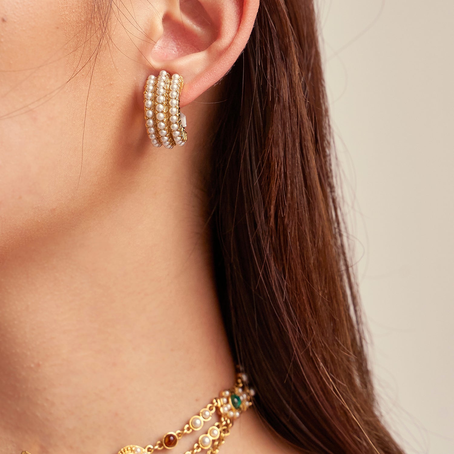 Model wearing Ben-Amun pearl earrings paired with pearl and czech glass stone gold necklace 