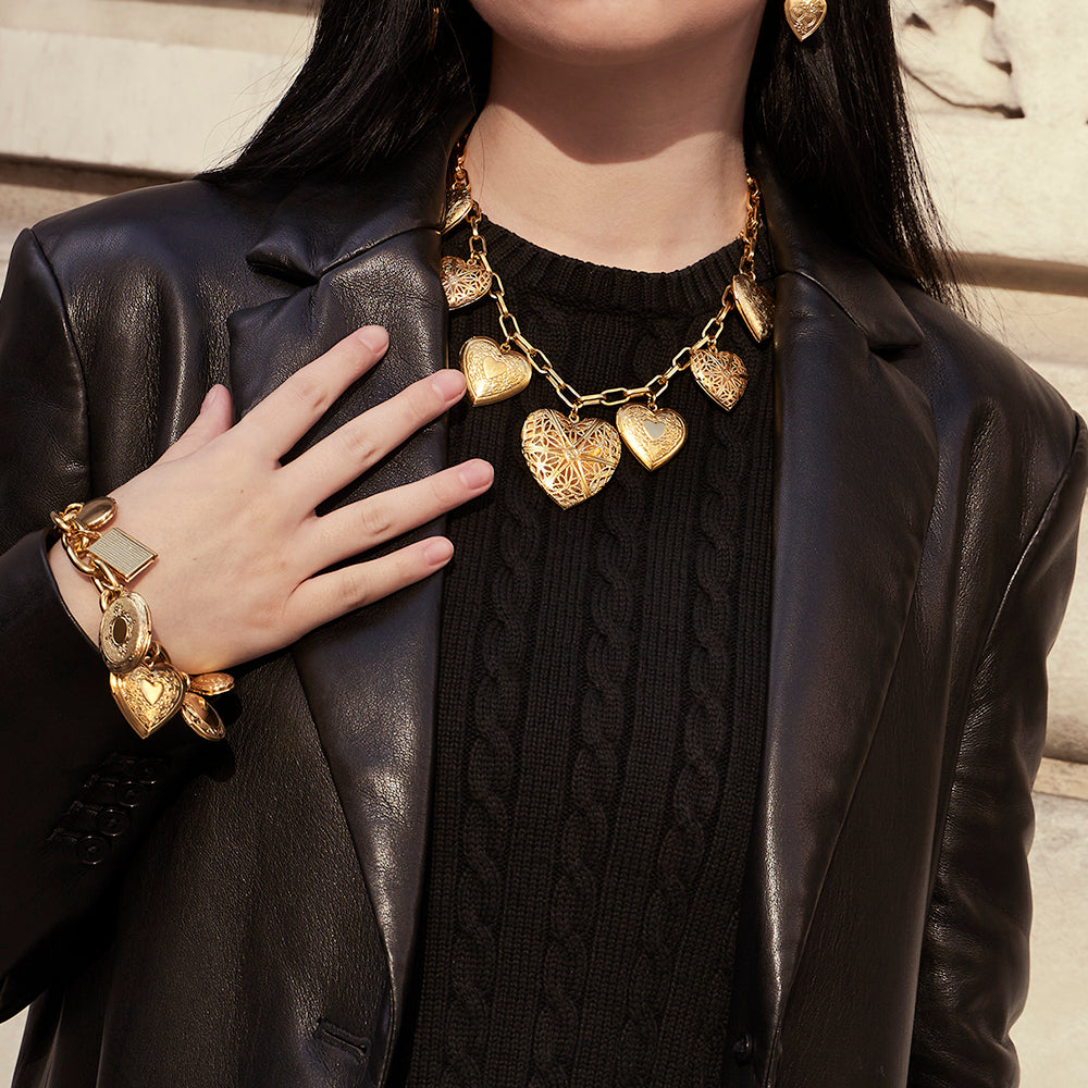 model wearing gold heart locket bracelet and necklace