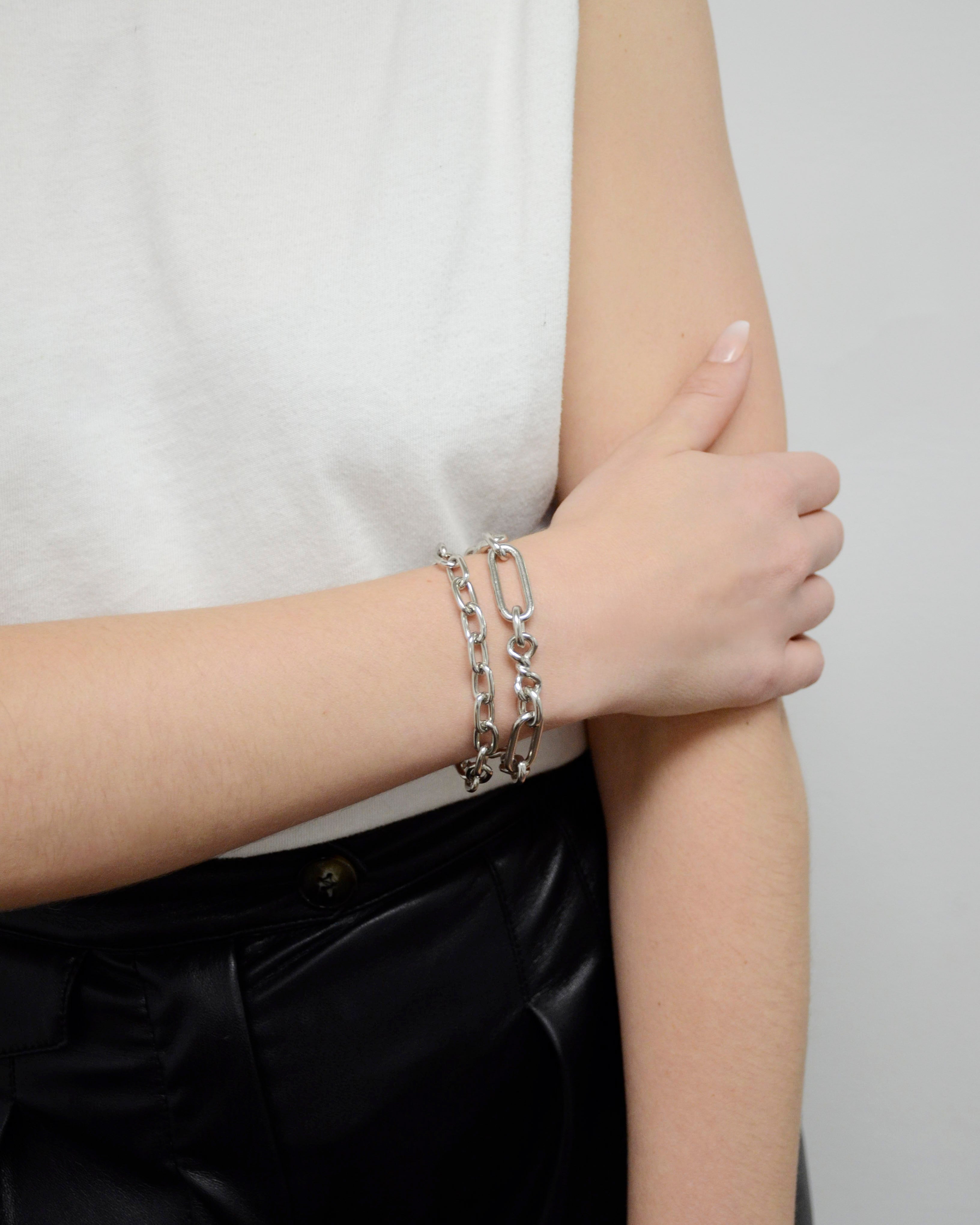 Model wearing two handmade ben-amun silver link bracelets 